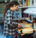Luke chopping vegetables, cooking with bamboo steamer